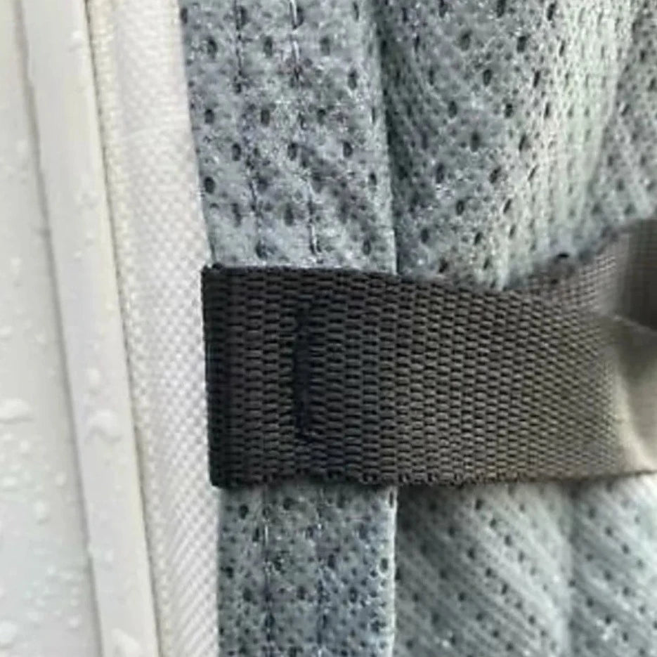 A close up of the strap that is sewn to the cover.