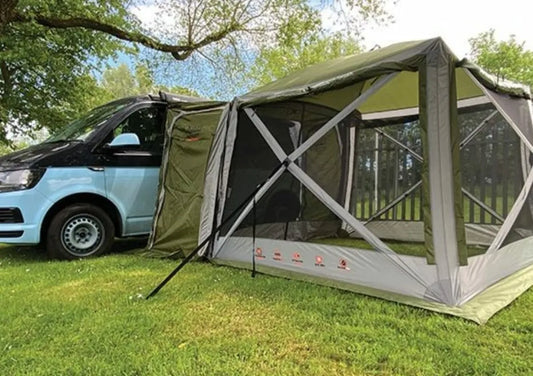 The Screen House 4 Pro is zipped and connected to a van, in the outdoors