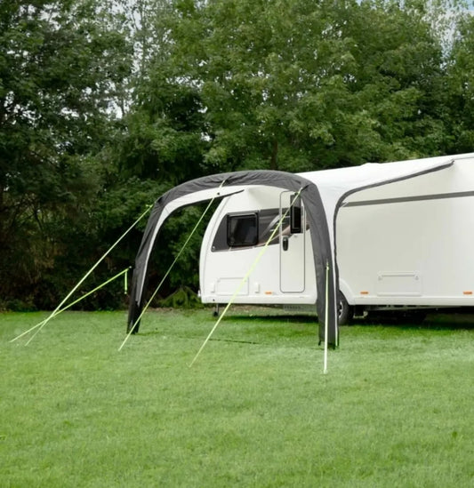 The Solar 4000 Air awning is pitched up beside a camper van.