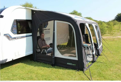 A man sitting inside the The Eclipse pro 380L Air Awning