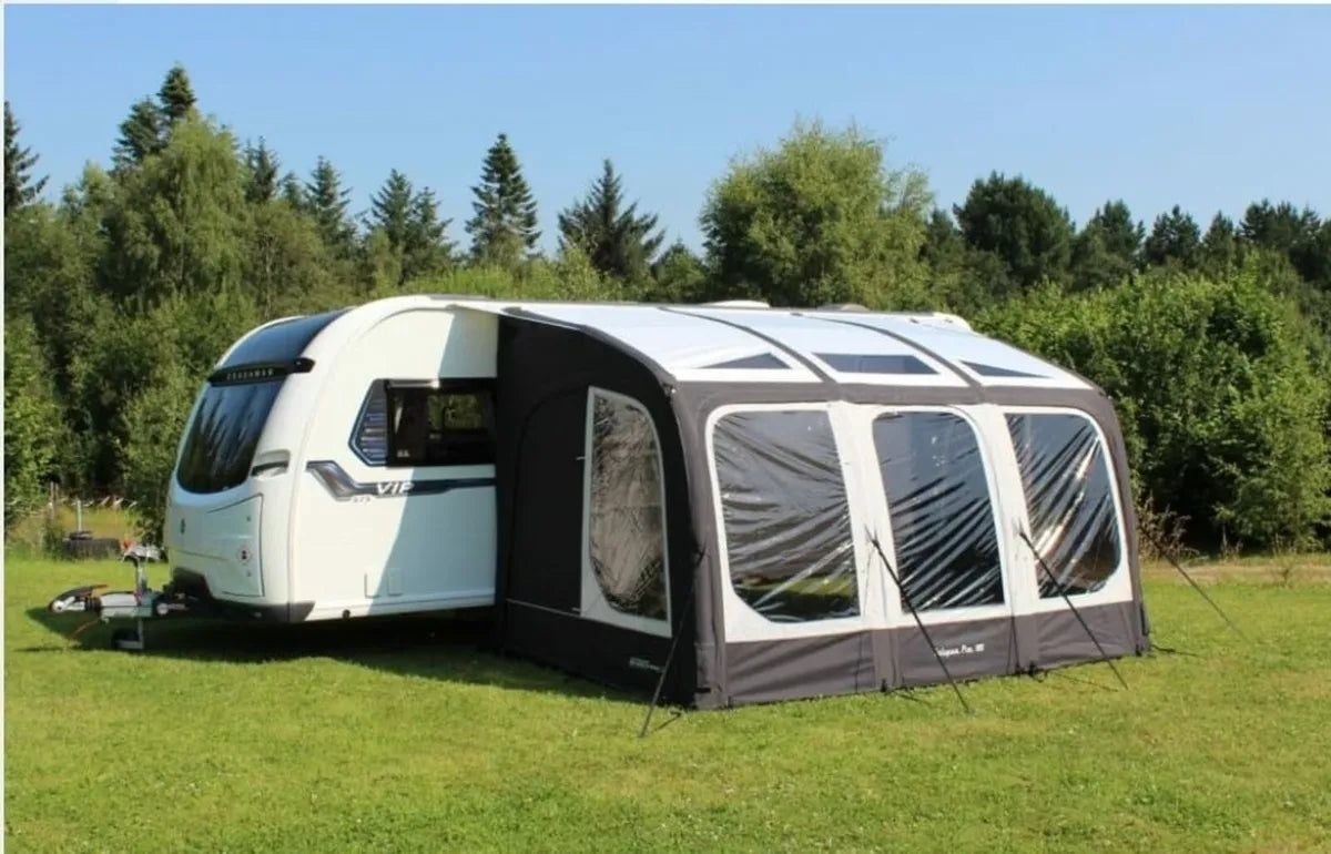 The Eclipse pro 380L Air Awning is pitched up beside a caravan with three panels