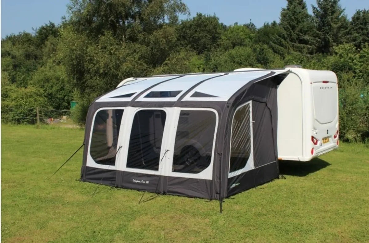 The Eclipse pro 380L Air Awning is pitched with three panels against a caravan.